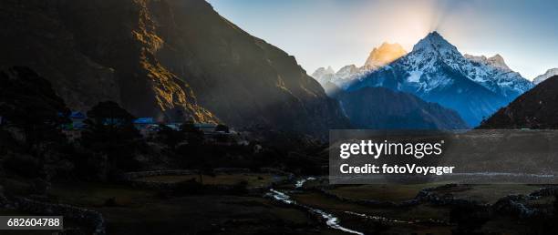 rays of light illuminating mountain valley sherpa villge himalayas nepal - kangtega stock pictures, royalty-free photos & images