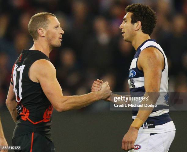 James Kelly of the Bombers celebrates the win on the final siren with former teammate Nakia Cockatoo of the Cats in his 300th match during the round...