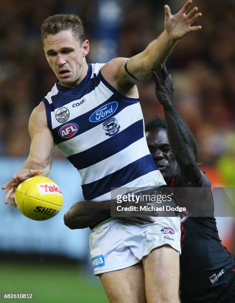 Joel Selwood of the Cats is tackled by Anthony McDonald-Tipungwuti of the Bombers during the round eight AFL match between the Essendon Bombers and...