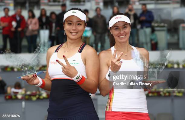 Yung-Jan Chan of Taipei and Martina Hingis of Switzerland celebrate with the winners trophies after defeating Timea Babos of Hungary and Andrea...