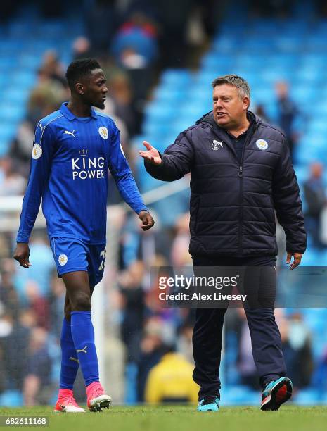Wilfred Ndidi of Leicester City speaks to Craig Shakespeare, manager of Leicester City as they walk off after the Premier League match between...