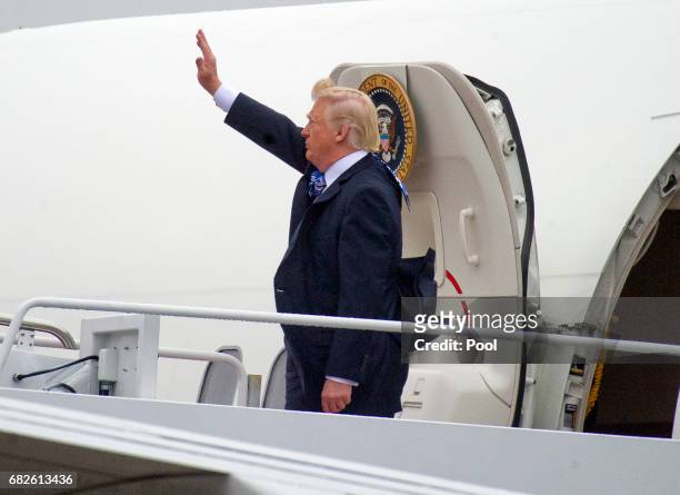 President Donald Trump waves as he boards Air Force One to fly to Lynchburg, Virginia to make remarks at the Liberty University Commencement ceremony...