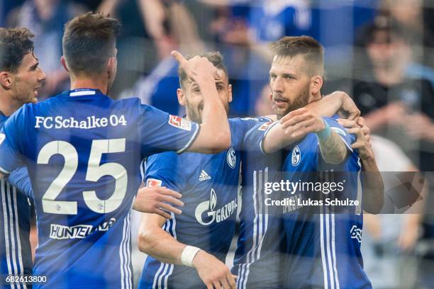 Players of Schalke celebrate their teams first goal scoring by Guido Burgstaller during the Bundesliga match between FC Schalke 04 and Hamburger SV...