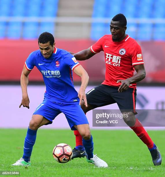 Assani Lukimya of Liaoning Whowin and Alan Kardec of Chongqing Lifan compete for the ball during the 9th round match of 2017 Chinese Football...