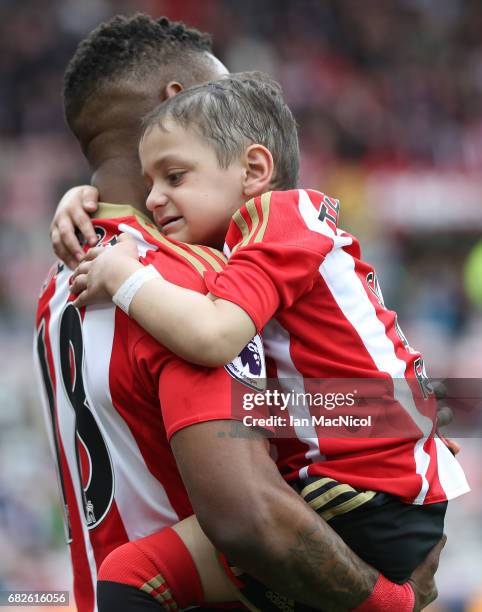 Jermain Defoe of Sunderland and Bradley Lowery are seen walking out prior to the Premier League match between Sunderland and Swansea City at Stadium...