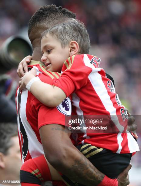 Jermain Defoe of Sunderland and Bradley Lowery are seen walking out prior to the Premier League match between Sunderland and Swansea City at Stadium...