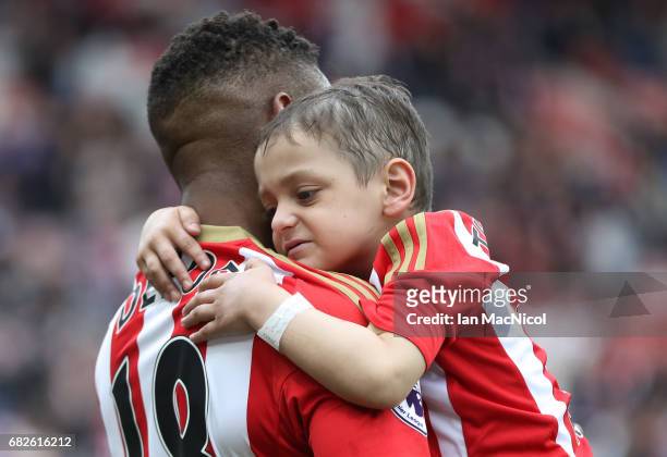 Jermain Defoe of Sunderland and Bradley Lowery are seen walking out prior to the Premier League match between Sunderland and Swansea City at Stadium...
