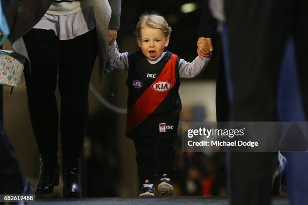 The son of James Kelly of the Bombers walks out for his 300th match during the round eight AFL match between the Essendon Bombers and the Geelong...