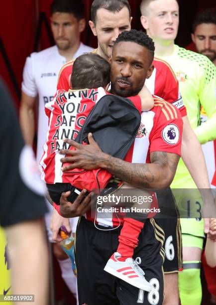 Jermain Defoe of Sunderland carries out mascot Bradley Lowery during the Premier League match between Sunderland and Swansea City at Stadium of Light...