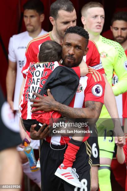 Jermain Defoe of Sunderland carries out mascot Bradley Lowery during the Premier League match between Sunderland and Swansea City at Stadium of Light...