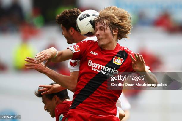 Tin Jedvaj of Bayer 04 Leverkusen challenges for the headed ball with Jonas Hector of Koeln during the Bundesliga match between Bayer 04 Leverkusen...