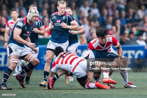 Yoshitaka Tokunaga of Japan puts a tackle on Jamie Hood of Hong Kong during the Asia Rugby Championship 2017 match between Hong Kong and Japan on May...
