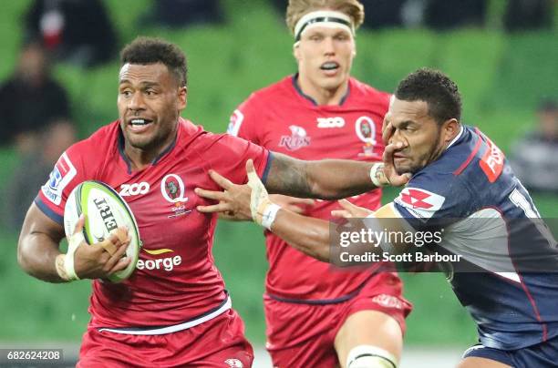 Samu Kerevi of the Reds is tackled by Sefanaia Naivalu of the Rebels during the round 12 Super Rugby match between the Melbourne Rebels and the...