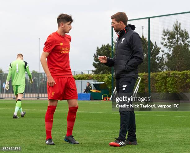 Anthony Glennon of Liverpool talks with coach Steven Gerrard before the Manchester City v Liverpool U18 Premier League game at Etihad Campus on May...