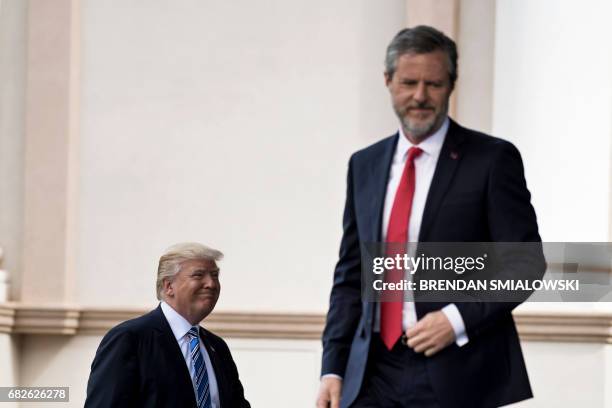 President Donald Trump and President of Liberty University Jerry Falwell arrive for Liberty University's commencement ceremony May 13, 2017 in...