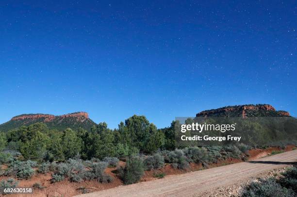 This time exposed shot taken at midnight, shows the stars and the two bluffs known as the "Bears Ears" in the Bears Ears National Monument on May 12,...