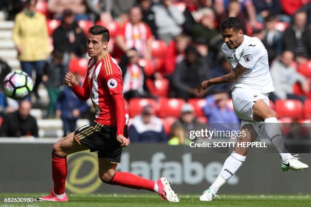 Swansea City's English defender Kyle Naughton shoots past Sunderland's Spanish defender Javier Manquillo to score their second goal during the...