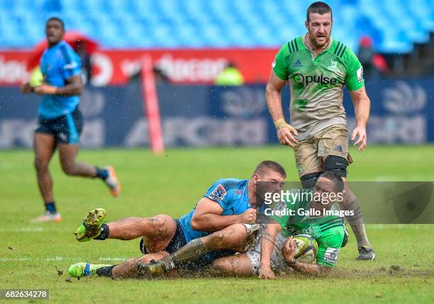 Aaron Smith of the Highlanders is tackled by Jaco Visagie of the Bulls during the Super Rugby match between Vodacom Bulls and Highlanders at Loftus...
