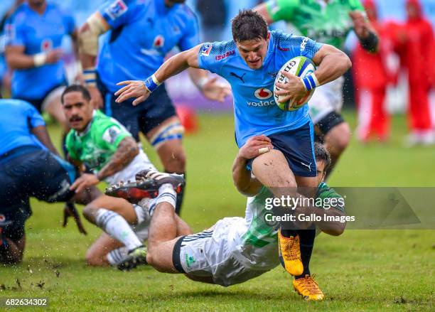 Dillon Hunt of the Highlanders tackles Piet van Zyl of the Bulls of the Bulls during the Super Rugby match between Vodacom Bulls and Highlanders at...