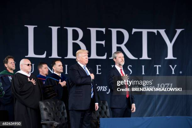 President Donald Trump , President of Liberty University Jerry Falwell , and others participate in the Pledge of Allegiance during Liberty...