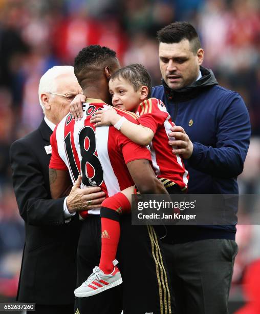 Jermain Defoe of Sunderland hands Bradley Lowery back to his Dad Carl Lowery prior to the Premier League match between Sunderland and Swansea City at...