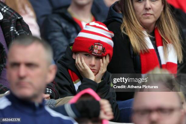 Young Sunderland fan holds his head in disappointment during the Premier League match between Sunderland and Swansea City at the Stadium of Light on...