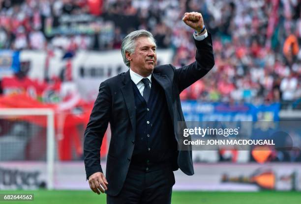 Bayern Munich's Italian head coach Carlo Ancelotti celebrates with fans at the end of the German first division Bundesliga football match between RB...