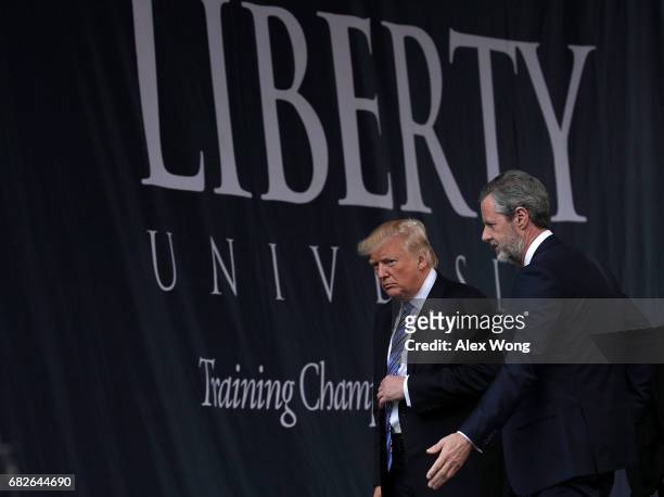 Accompanied by President Jerry Falwell , U.S. President Donald Trump leaves after he delivered keynote address during the commencement at Liberty...