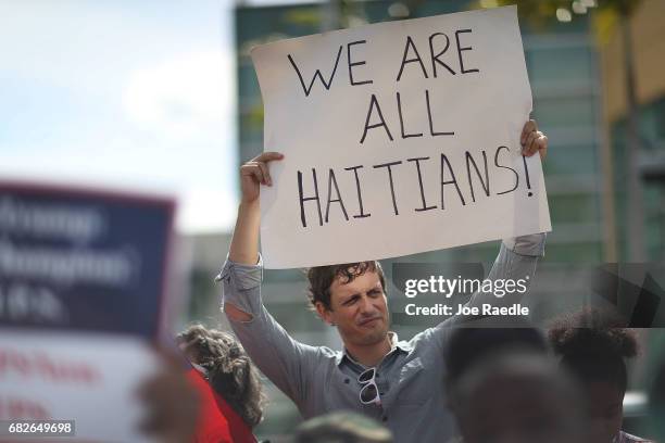 David McDougal joins others as they protest the possibility that the Trump administration may overturn the Temporary Protected Status for Haitians in...