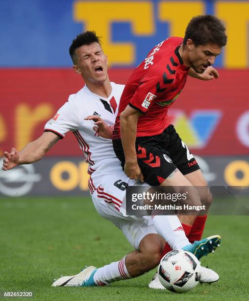 Aleksandar Ignjovski of Freiburg is challenged by Alfredo Morales of Ingolstadt during the Bundesliga match between SC Freiburg and FC Ingolstadt 04...