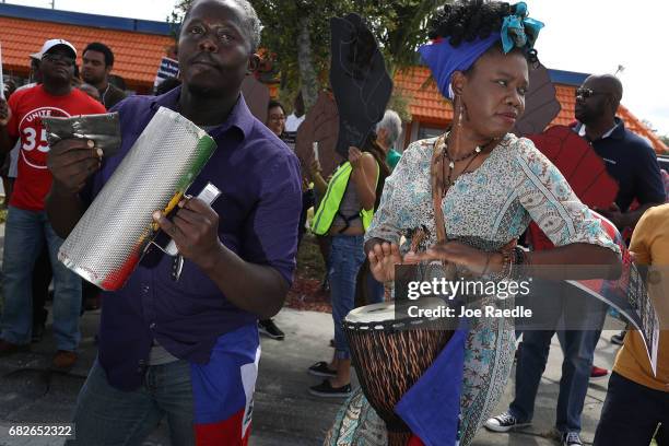 Salusa Bosquin and Cherdeline Pierre Louis join others as they protest the possibility that the Trump administration may overturn the Temporary...