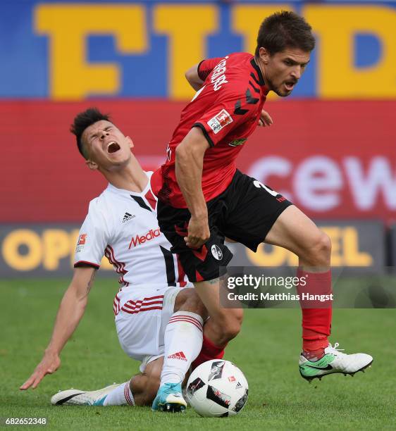 Aleksandar Ignjovski of Freiburg is challenged by Alfredo Morales of Ingolstadt during the Bundesliga match between SC Freiburg and FC Ingolstadt 04...