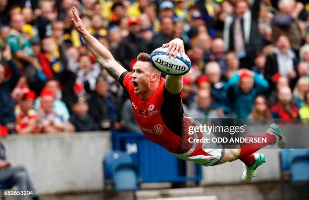 Saracens' English wing Chris Ashton dives over the try line to score the opening try during the rugby union European Champions Cup Final match...