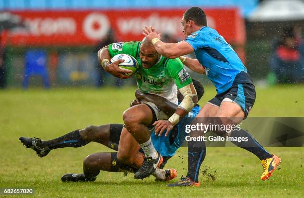 Patrick Osborne of the Highlanders tackled by Jamba Ulengo and Jesse Kriel of the Bulls during the Super Rugby match between Vodacom Bulls and...