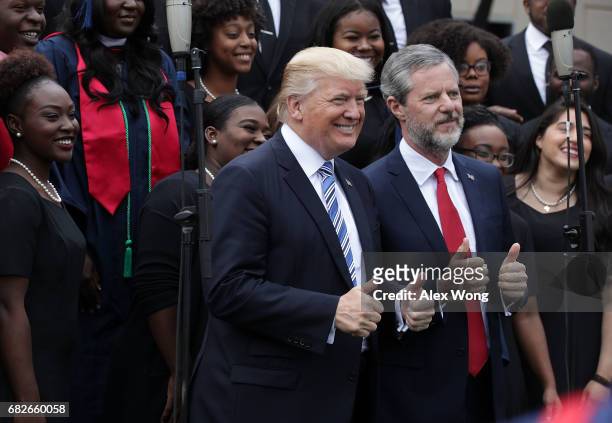 President Donald Trump and Jerry Falwell , President of Liberty University, pose for photos with members of gospel choir Lu Praise during a...