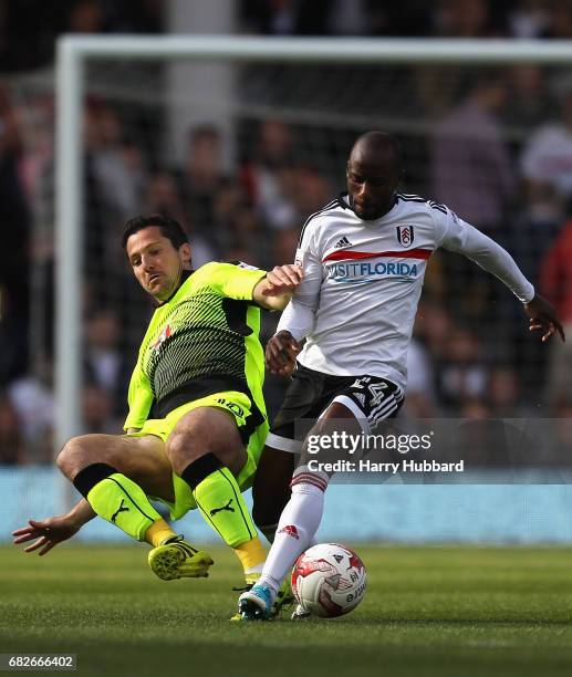 Yann Kermorgant of Reading tackles Sone Aluko of Fulham during the Sky Bet Championship Play off semi final 1st leg match between Fulham and Reading...