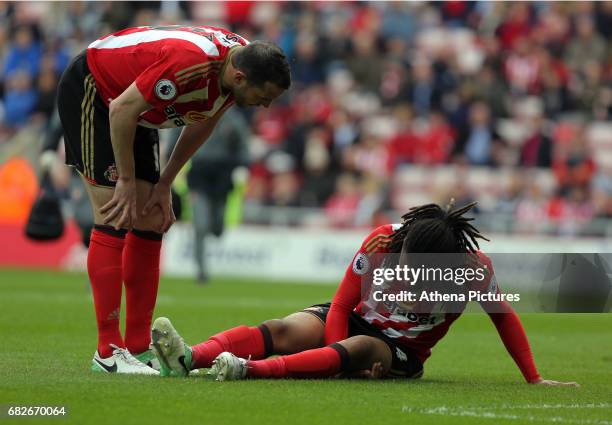 Jason Denayer of Sunderland is injured on the ground being spoken to by team mate John O'Shea during the Premier League match between Sunderland and...