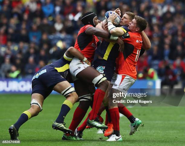 David Strettle of Clermont Auvergne is tackled by Maro Itoje and Owen Farrell of Saracens during the European Rugby Champions Cup Final between ASM...