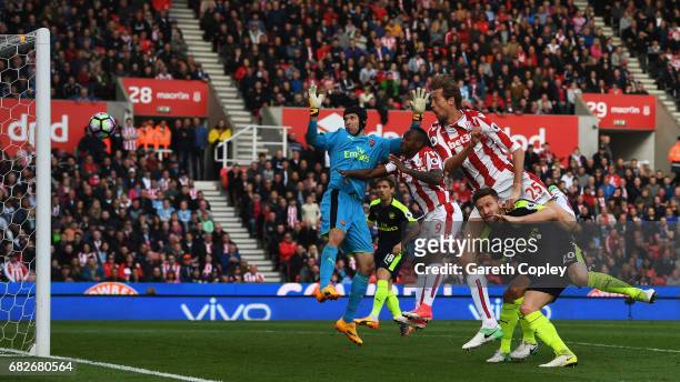 Peter Crouch of Stoke City scores his sides first goal past Petr Cech of Arsenal during the Premier League match between Stoke City and Arsenal at...