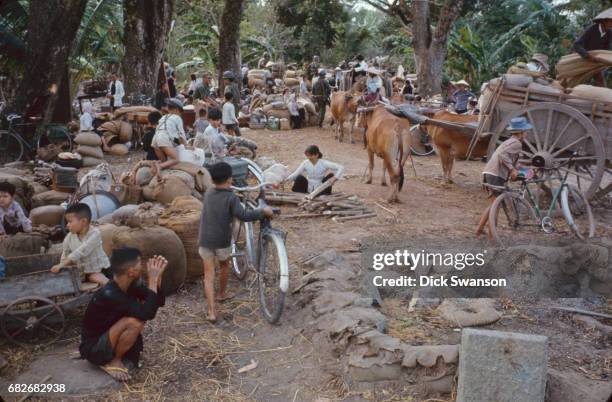 View of civilians and their belongings as they wait to evacute, as part of Operation Cedar Falls, from the Iron Triangle village of Ben Suc, Vietnam,...