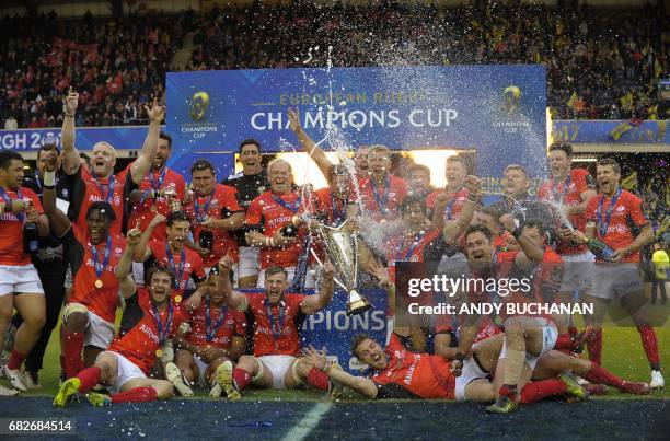 The champagne is sprayed as Saracens players celebrate their win with the trophy on the pitch after the rugby union European Champions Cup Final...