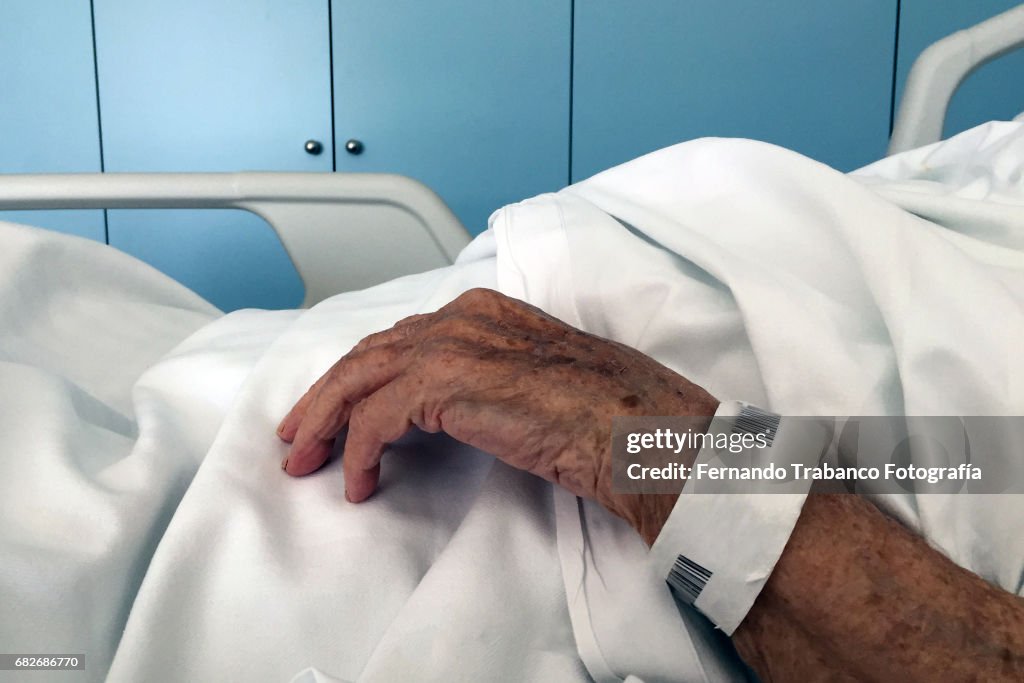 Sick old woman in a bed