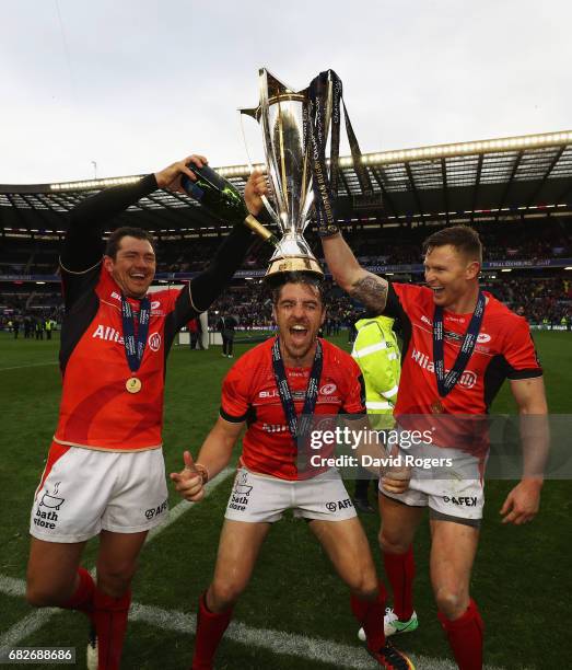 Alex Goode, Chris Wyles and Chris Ashton of Saracens celebrate with the trophy following his team's 28-17 victory during the European Rugby Champions...