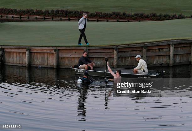 Workers set up the virtual reality camera on the 17th hole during previews prior to the start of THE PLAYERS Championship on THE PLAYERS Stadium...