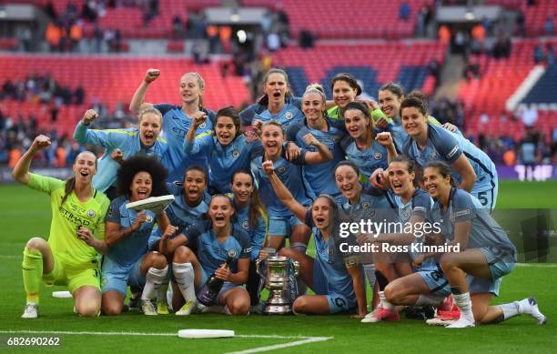 The Man City Ladies team pose for a photo with the trophy after they won the SSE Women's FA Cup Final between Birmingham City Ladies and Manchester...