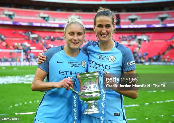 Steph Houghton of Manchester City and Jill Scott of Manchester City pose with the trophy after the SSE Women's FA Cup Final between Birmingham City...