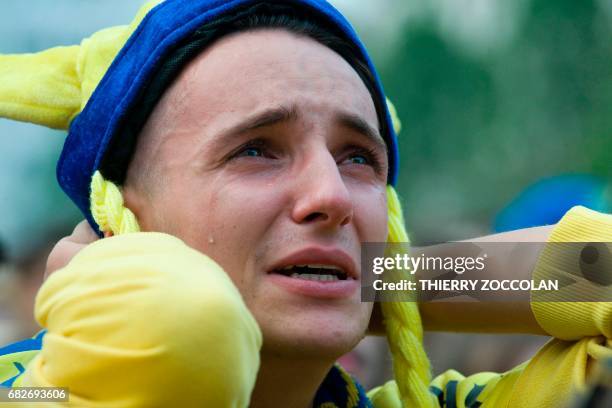 Clermont-Ferrand's supporters react as they watch on a giant screen the European champions Cup rugby union final match Saracens vs Clermont-Ferrand,...