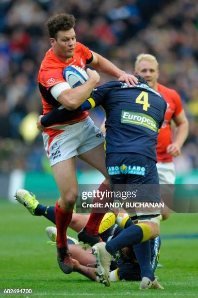 Saracen's Scottish centre Duncan Taylor is tackled by Clermont's French lock Arthur Iturria during the rugby union European Champions Cup Final match...