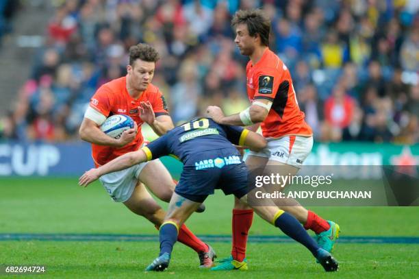 Saracen's Scottish centre Duncan Taylor is tackled by Clermont's French fly-half Camille Lopez during the rugby union European Champions Cup Final...