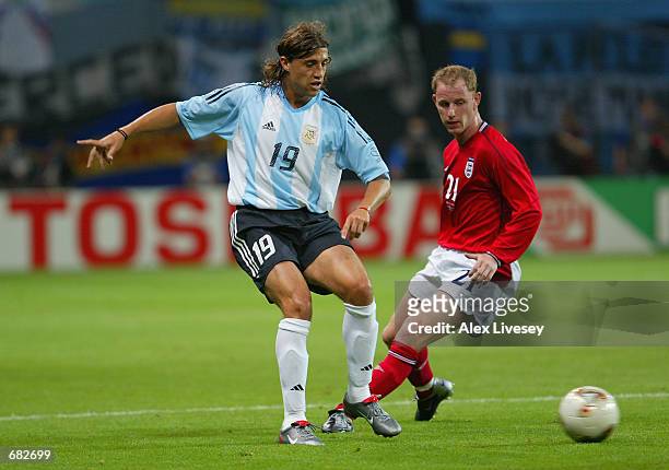 Hernan Crespo of Argentina lays the ball off as Nicky Butt of England closes in during the FIFA World Cup Finals 2002 Group F match played at the...